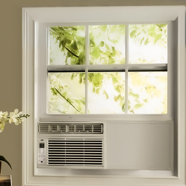 Window air conditioner installed in a room with a view of greenery outside.